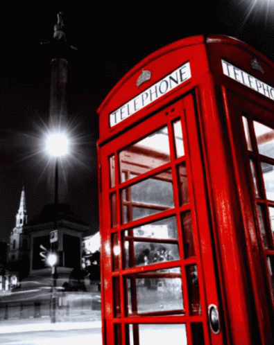 a phone booth on a city street at night
