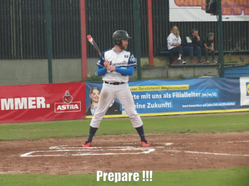 a baseball player prepares to hit a ball