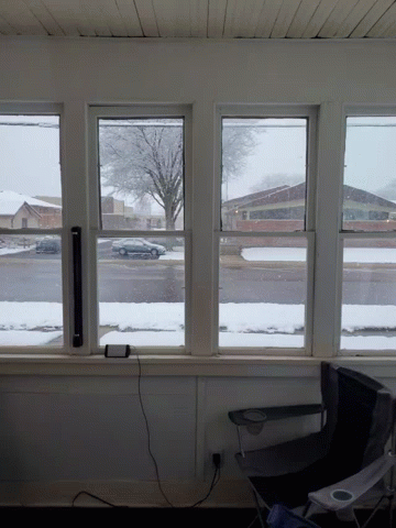 a window with some snow outside in the winter
