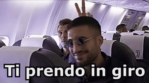 a man in the aisle of an airplane with the wordtiprendo ingiro in spanish