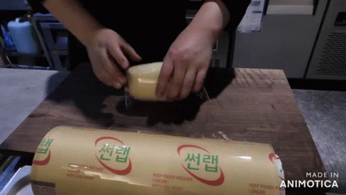 a person that is using a plastic machine to fill a tube with soing