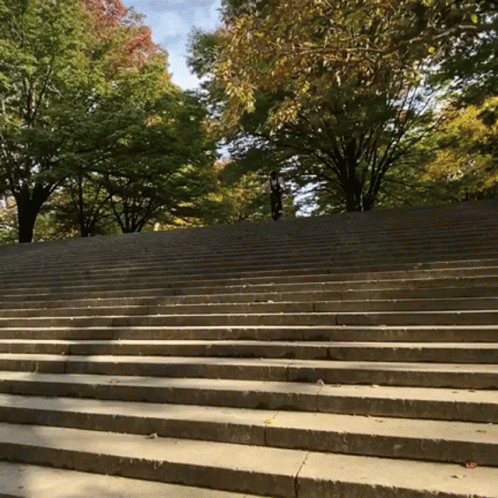 a man riding a skateboard down a staircase