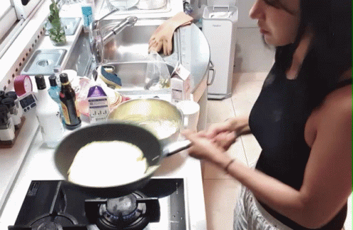 woman frying soing in a wok on the stove top