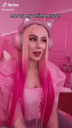 a woman wearing headphones and wearing a pink wig
