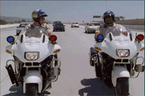 a picture of two people on motorcycles driving down a highway