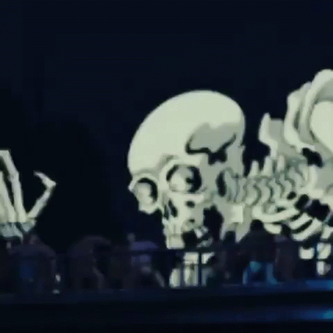 skeleton sculpture displayed in large museum hall at night