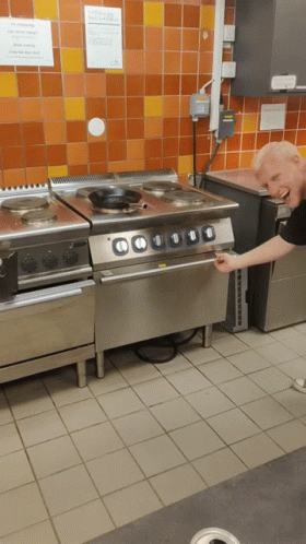 an old man reaches for soing on the stove