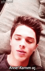 the teen man is asleep with his eyes closed