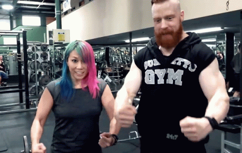 two people holding hands at a gym