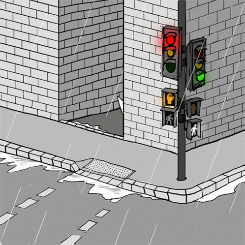 a red light is in front of a brick building and a white wall