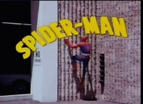a picture of a spiderman leaning up on a building