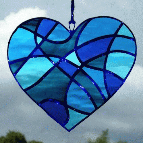 a stained glass heart hanging from a hook