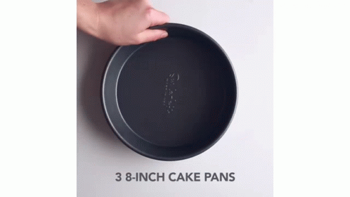 two hands are holding an empty pan with three holes