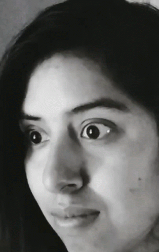 a woman is staring at the camera with her eyes wide open