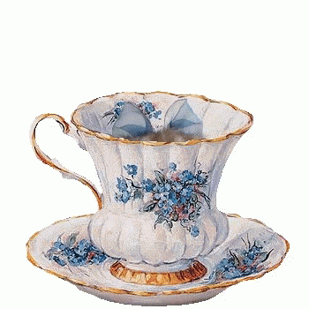 a white porcelain cup with gold flowers and two saucers