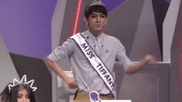 a contestant in a contest standing with his arms outstretched