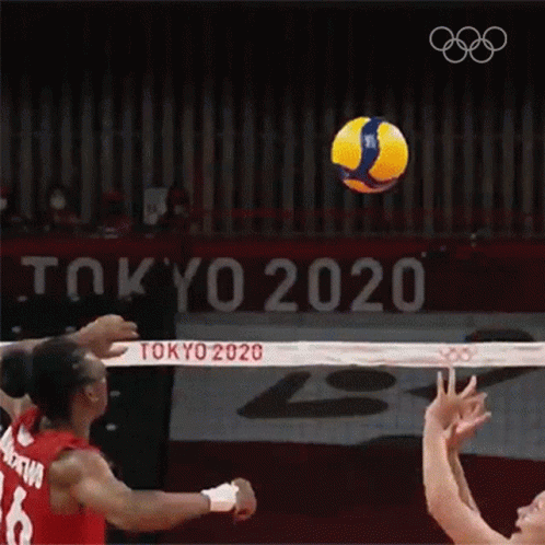 two women on opposite teams playing volleyball at the olympic ceremony
