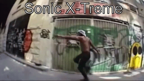 a man in front of a metal round object with words sonic x - treme