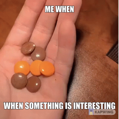 some balls sitting on top of someones hand and some pills