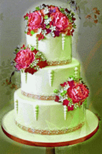 the wedding cake was decorated in green and purple flowers