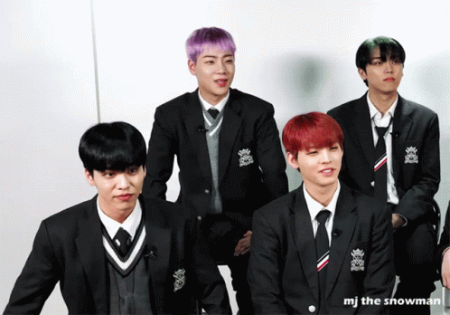 four male in black suits and two pink dyed hair