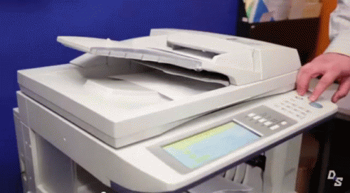 a close up of a person operating a copier machine