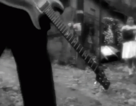 a blurry pograph of a man playing an electric guitar