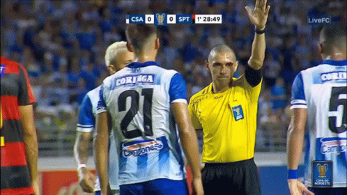 the referee in the crowd is pointing his finger up