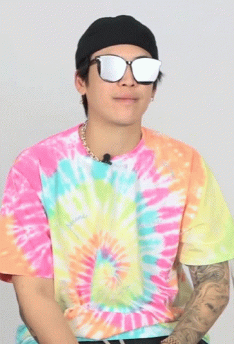 a man wearing sunglasses and a tie dyed shirt