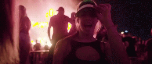 an image of a girl at a concert dancing with a band