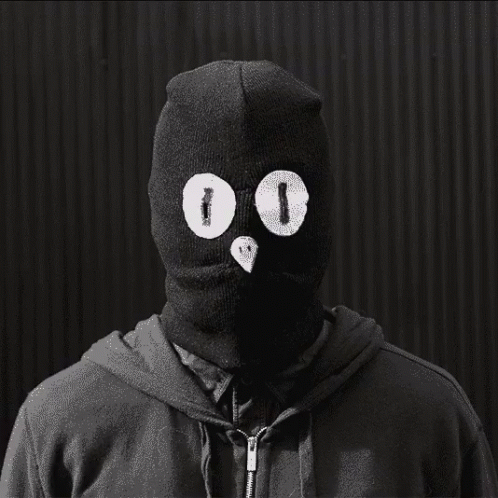 a person in a black hoodie has eyes drawn on them