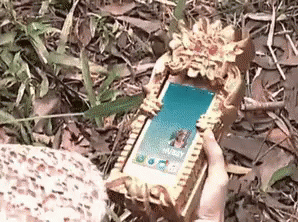 a cell phone lying on top of grass covered in dirt