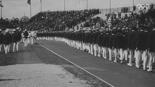 a crowd of people watching men in baseball uniforms