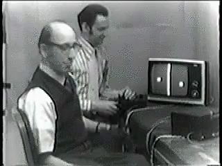a tv and some men are playing an old video game
