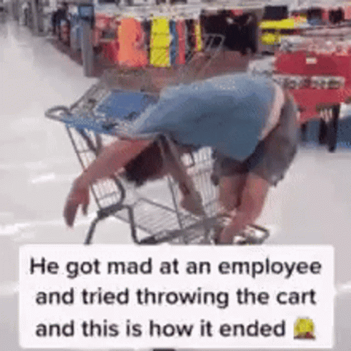 the man is hing the shopping cart in the aisle of the store