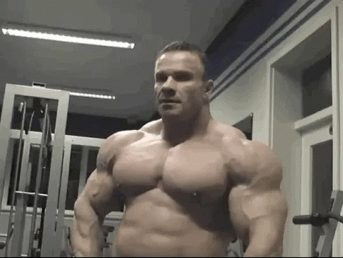 this man is posing for the camera and posing with his massive muscular muscles