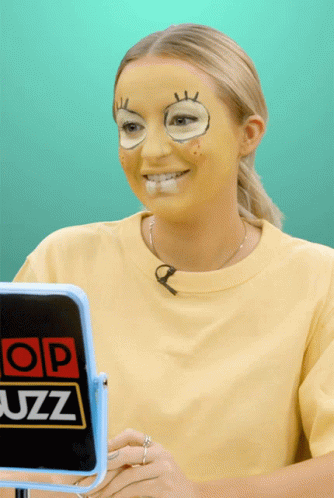 a woman wearing blue face paint while holding a quiz sign