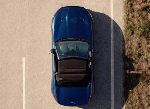 an overhead view of a car parked in a parking space