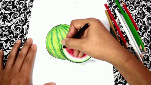 a person drawing watermelon on paper with colored pencils