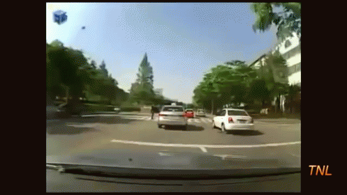 a car driving past another car on the road