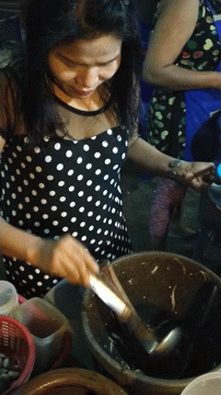 women in polka dot shirts are preparing food in containers