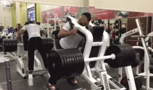 a person in the gym lifting a barbell