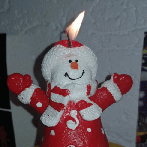 a blue and white teddy bear with a birthday candle
