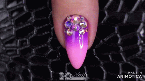 purple stilettote nail with colorful crystal stones