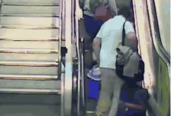 passengers with their luggage getting off the escalator at an airport