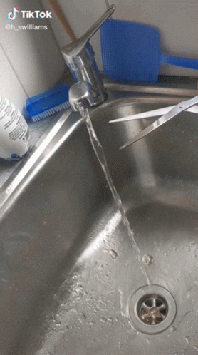 a sink in a bathroom with dirty water