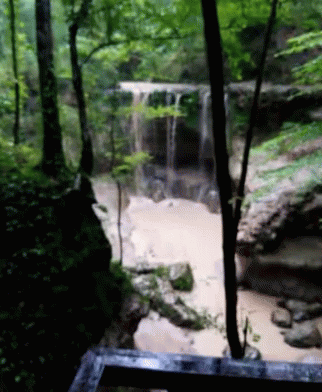 a creek that has a large waterfall flowing into it