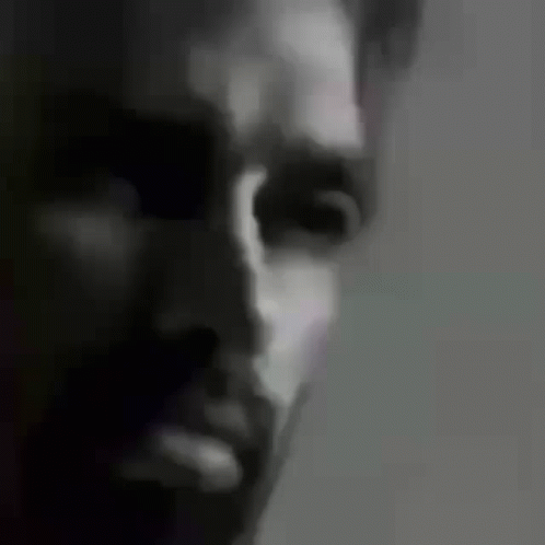 a black and white po of a man's face with the light turned on