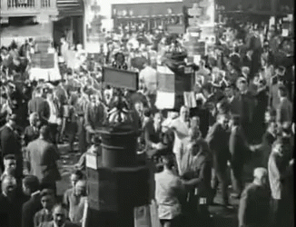 a large crowd is standing near a building