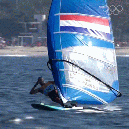 a person windsurfing on the beach on a sunny day